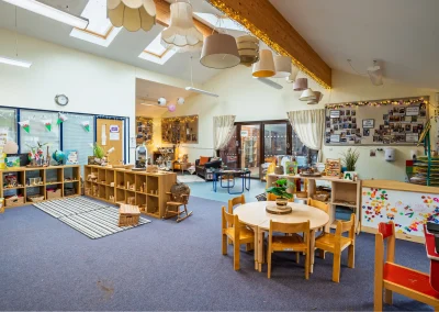 Spacious Little Gems preschool classroom with child-size tables, books and activity areas