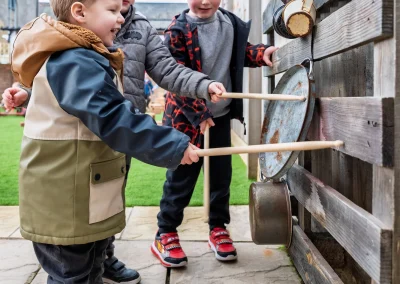 Children exploring outdoor music at Monmouth Day Nursery