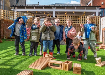 Children playing together outdoors at Monmouth Day Nursery